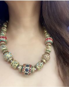 A colorful Navratan necklace from Punjab is a traditional piece of jewelry adorned with nine different gemstones, each representing one of the nine planets according to Hindu astrology. These gemstones, known as Navratna or Navaratna, typically include diamonds, rubies, emeralds, sapphires, pearls, coral, topaz, cat's eye, and garnet. The necklace is designed to bring good fortune and balance to the wearer's life, reflecting cultural beliefs and aesthetic preferences. Navratan necklaces are prized for their intricate craftsmanship and spiritual significance, making them a cherished part of Punjab's cultural heritage and adornment traditions. Bohemian Bridal Necklace With Colorful Beads, Multicolor Bridal Necklace With Polished Round Beads, Multicolor Polished Round Beads Bridal Necklace, Handmade Multicolor Bridal Necklace With Round Beads, Artisan Multicolor Necklaces With Large Beads, Artisan Multicolor Necklace With Large Beads, Traditional Multicolor Jewelry With Faceted Beads, Traditional Multicolor Beaded Bridal Necklace, Traditional Jewelry With Faceted Beads