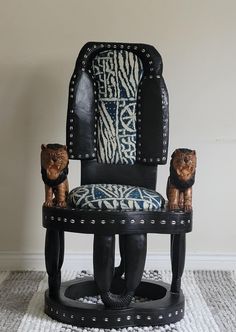 a chair with two bears sitting on it's back legs in front of a wall