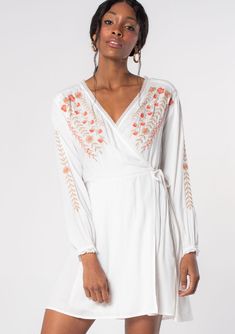 [Color: Ivory/Coral] A model wearing a white mini wrap dress with pink floral embroidery. Dress Lyrics, Bohemian Mini Dress, Bohemian Dresses, Mini Wrap, Back Women, Black Wrap Dress, Mini Wrap Dress, Classic Mini, Bohemian Dress