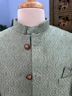 This 3 Piece Kurta Pajama Set is a luxurious choice for special occasions. It features a stylish Embroidered Sequins Jacket, Kurta and Trouser pant. Get ready to impress in this classic and timeless attire! Feel confident and look your best with Kurta Pajama with Jacket style Set Ready to wear for any occasions such as Diwali, House Warming, Pooja, Ramadan, Eid. Kurta color : Pista Green shade (See item pic for better shade, Color shade is very subjective) Waist coat: Pista Green shade with intricate Embroidery design with Sequins Pant color : Pista Green shade Pant style Pocket : Yes Fabric : Cotton Silk Blend -Silk Design TPKP- 1386 Actual color of the dress may slightly vary due to the screen resolution. Refer the size chart for measurements Luxury Pista Green Nehru Jacket For Diwali, Formal Pista Green Nehru Jacket For Festive Occasions, Elegant Pista Green Bandhgala With Long Sleeves, Fitted Pista Green Sets For Ceremonial Occasions, Festive Long Sleeve Sets With Intricate Embroidery, Festive Sets With Intricate Embroidery And Long Sleeves, Festive Stand Collar Kurta With Intricate Embroidery, Pista Green Raw Silk Traditional Wear With Long Sleeves, Festive Designer Nehru Jacket With Stand Collar