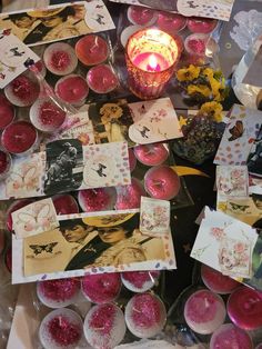 many cards and candles are on the table