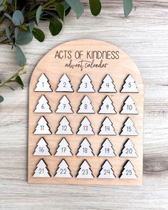 the acts of kindness wooden calendar with trees on it