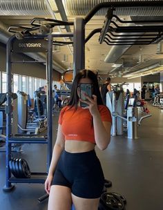 a woman taking a selfie in the gym