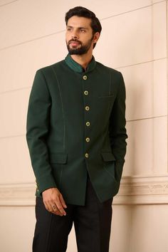 Emerald green tapered bandhgala in a premium suiting fabric with a fluted satin collar and handcrafted novelty buttons. Comes with a cotton-satin formal shirt and trouser.
Components: 3
Pattern: Plain
Neckline: Stand Collar
Sleeve Type: Straight Full
Fabric: Bandhgala : Suiting Fabric, Shirt : Cotton Satin, Trousers : Suiting Fabric
Color: Emerald Green
Other Details: 
Fluted satin collar
Novelty buttons
Occasion: 
Cocktail and Reception - Aza Fashions Fitted Green Bandhgala With Naqshi Detailing, Green Fitted Kurta With Naqshi, Fitted Green Bandhgala With Naqshi, Elegant Pista Green Bandhgala For Eid, Formal Green Traditional Wear With Naqshi Detailing, Green Formal Traditional Wear With Naqshi Embroidery, Formal Green Traditional Wear With Naqshi, Green Naqshi Traditional Wear For Formal Occasions, Festive Green Bandhgala With Naqshi Detailing