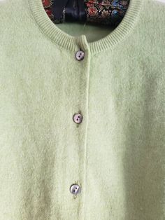 This is a vintage cardigan sweater. It is green, long sleeved and has Mother of Pearl buttons. I do not know its size as there is no label. Please refer to the measurements for a proper fit. I think this sweater is possibly lambswool or angora. I am not sure due to the missing label. Please note, there are 2 or 3 spots that are a bit dark. I dont think these are stains, just little dark marks in the fibers. They are evident in the 4th and 5th pictures. Please feel free to ask to see an image. Th Green Button-up Winter Cardigan, Green Button-up Winter Sweater, Green Buttoned Sweater For Layering, Vintage Green Cardigan For Fall, Vintage Long Sleeve Cardigan For Layering, Vintage Style Long Sleeve Cardigan For Layering, Green Crew Neck Cardigan For Fall, Classic Green Long Sleeve Cardigan, Cozy Green Sweater With Buttons