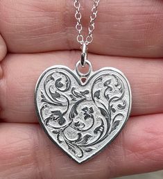 "Sterling silver heart is extremely detailed, made from a hand engraved model. It measures 29mm by 24mm ( without rings on top). Comes with 18\" sterling silver chain. 6.7g. Available in 14kt gold also. Money back guarantee within 14days. Buyer pays return shipping and must be returned in original condition with box and no alterations." Silver Etched Necklace For Valentine's Day, Valentine's Day Silver Etched Necklace, Stamped Sterling Silver Heart Pendant Necklace, Silver Sterling Heart Necklace For Memorial, Antique Silver Engraved Heart Jewelry, Silver Heart-shaped Etched Necklace, Silver Jewelry With Engraving Option For Valentine's Day, Etched Heart Silver Necklace, Antique Silver Engraved Jewelry For Valentine's Day