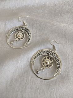 These gorgeous drop earrings feature filigree moons, suns, and star charms enclosed in a celestial circle. Perfect piece for a little everyday magic! Choose between silver or bronze Celestial Style Nickel-free Metal Hoop Earrings, Celestial Style Silver Metal Jewelry, Celestial Metal Hoop Earrings, Celestial Metal Hoop Earrings Nickel Free, Celestial Style Metal Hoop Earrings Nickel Free, Nickel Free Celestial Metal Hoop Earrings, Celestial Style Nickel Free Metal Hoop Earrings, Nickel Free Alloy Round Hoop Earrings, Vintage Star-shaped Metal Jewelry