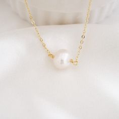 This shiny dainty pearl necklace is definitely durable for everyday wear. It is perfect on its own and also looks great for layering with other necklaces in your collection. Pearl is the birthstone for June. All items are handmade by me in my home studio. ★ D E T A I L Made from high-quality materials~ Waterproof, hypoallergenic, wear 24/7. * 925 sterling silver * 14K gold filled * Freshwater Pearl - With a 2" extender chain * W H A T  I S  14 K  G O L D - F I L L E D * Gold-filled jewelry legal Delicate Everyday Pearl White Necklace, Delicate Pearl White Necklace For Everyday, Simple Pearl Necklace Gift, Simple Pearl Necklace For Gift, Simple Pearl Drop Necklace For Gifts, Simple Pearl Chain Necklace As Gift, Simple Pearl White Jewelry With Pearl Charm, Simple Pearl Necklace With Clavicle Chain As Gift, Simple Pearl Clavicle Chain Necklace As Gift