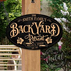 the back yard sign is attached to a wooden post