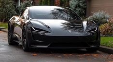 a black sports car is parked on the street