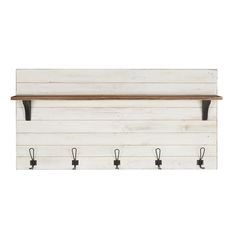 a white wall mounted coat rack with four hooks