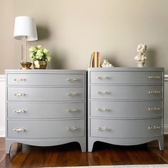 two gray dressers sitting next to each other on top of a hard wood floor