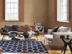 a living room with two couches and a coffee table in front of the window