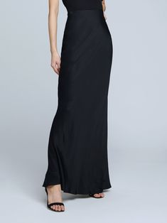 A stunning, understated maxi skirt in pure black. Bias-cut, silk-like fabric falls in a subtle, lustrous cling over the figure, enhancing and elongating the silhouette. Smooth elastic waist with no closures. Sleek Long Skirt For Night Out, Sleek Full-length Bias-cut Maxi Dress, Elegant Floor-length Satin Skirt, Chic Silk Maxi Dress For Black-tie Events, Chic Full-length Silk Maxi Skirt, Chic Full Length Silk Maxi Skirt, Evening Maxi Skirt With Satin Finish, Evening Satin Maxi Skirt With Satin Finish, Evening Satin Skirt With Bias Cut