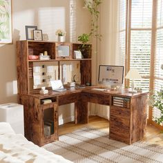 a wooden desk sitting in front of a window next to a white rug on top of a hard wood floor