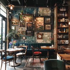 a restaurant with tables, chairs and pictures on the wall