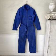 Hello and welcome to the Textile Trunk! Please follow us on Instagram, we are @textiletrunk  Absolutely unbelievable! This is a vintage French mechanic jumpsuit coveralls ~ just about as cool as they get. . These date to the 1950s - 1970's and are an absolute dream! They are a wonderful French  blue at their best ~~ The zipper is TWO WAY ~ love that ~*  MEASUREMENTS : These wonderful overalls measure approximately Waist: 30 inch waist ( it has some stretch)  Length: 38 inches long from waist to ankle cuff  Inseam: 28 inches CONDITION :  This jumpsuit is in as found not freshly laundered condition and can be machine washed and tumbled dry ~ these are timworn, stains on front and some on back ~ all part of the charm !   Inventory : Pants 26N Fitted Shortalls With Pockets For Workwear, Retro Fitted Long Sleeve Overalls, Vintage Fitted Denim Jumpsuit For Work, Fitted Vintage Denim Jumpsuit For Work, Vintage Blue Jumpsuits And Rompers For Workwear, Vintage Fitted Blue Overalls, Retro Blue Denim Jumpsuit With Pockets, Retro Workwear Overalls, Retro Blue Cotton Overalls