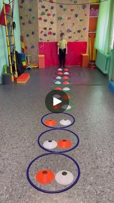 a child's play area with colorful circles and climbing walls