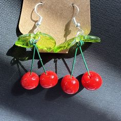 🍒 Trendy and unique dangling, cherry earrings, carefully created using polymer clay and resin. 🍒 Earrings are nickel free, hypoallergenic.  🍒 Earrings will be handmade so each pair might a slight variation from what is shown in the picture. These earrings are so much fun and a statement piece! Wear them with your cutest summer outfit and you'll stand out from the crowd! 😍 Red Resin Novelty Jewelry, Novelty Red Resin Jewelry, Trendy Red Resin Earrings, Red Resin Novelty Earrings, Red Plastic Earrings For Gift, Playful Plastic Dangle Jewelry, Fun Red Resin Jewelry, Red Novelty Plastic Jewelry, Trendy Red Plastic Earrings