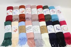 many different colors of scarves are laid out together