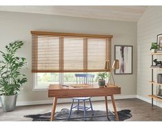 a home office with wooden blinds in the window