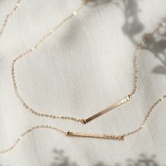 "The daintiest personalized necklace you'll ever meet--like a secret just for you! Perfect for teeny initials or other mini inscriptions you want to keep close. For those of you who prefer it subtle, this baby's for you.   Every piece is handcrafted and hand-personalized with love in La Conner, WA, using 90% recycled and 100% ethically sourced raw materials from the USA--because it's better that way. Includes free gift-ready packaging (featuring a care card and traditional letterpress goodies made by my dad)!  This piece is too small for coordinates; for a custom coordinates piece, please see: https://www.etsy.com/listing/289990687/ MATERIALS: * Gold = 14k gold filled * Silver = sterling silver * Rose gold = 14k rose gold filled DETAILS: * 30x2mm bar * Hand-personalized with traditional me Minimalist 14k Gold Filled Necklace For Personalized Gift, Delicate Everyday Jewelry With Custom Name, Everyday Rose Gold Name Necklace With Adjustable Chain, Minimalist Personalized 14k Gold Filled Necklace, Personalized Minimalist 14k Gold-filled Necklace, Personalized Minimalist 14k Gold Filled Necklace, Personalized Minimalist Gold Necklace, Everyday Rose Gold Name Necklace With Delicate Chain, Personalized 14k Gold Delicate Chain Necklace