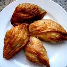 three croissants are on a white plate