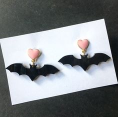 Statement bat earrings, with black pearlescent acrylic bats. I promise my pictures don't do them justice. -available on lead and nickel safe zinc alloy posts. 1.7in wide 1in long Goth Earrings, Bat Earrings, Spider Earrings, Alloy Earrings, Dope Jewelry, Black Bat, Fall Earrings, Pink Enamel, Halloween Earrings