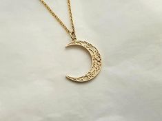 mens womens crescent moon necklace pendant made in 14k or 18k solid goldthe delicate patterns that make it more attractive are on the crescent moon pendant.model wears a 14k 1.7mm 50cm chain.free shipping on all orders via fedex!14k gold mens womens crescent moon pendant necklace weightpendant only 2.46g (±7%)with 1.4mm 42cm chain 5.11g (±7%)with 1.7mm 42cm chain 6.26g (±7%)with 2.2mm 42cm chain 8.21g (±7%)18k gold mens womens crescent moon pendant necklace weightpendant only 2.93g (±7%)with 1.4 Elegant Sun And Moon Design Half Moon Jewelry, Gold Plated Crescent Jewelry, Elegant Brass Jewelry With Moon Charm, Elegant Moon Shaped Brass Jewelry, Elegant Half Moon Brass Jewelry, Celestial Crescent Engraved Jewelry, Gold Plated Crescent Jewelry Gift, Yellow Gold Crescent Jewelry Gift, Crescent Moon Charm Necklace In 14k Gold