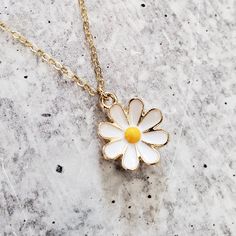 Step into a world of playful elegance with this Gold Dainty Daisy Charm Necklace. This adorable piece of jewelry is here to add a touch of enchantment to your everyday style. It's like capturing a piece of nature's cheerfulness and wearing it as a symbol of your vibrant spirit. This necklace brings a lighthearted touch to any outfit, whether you're dressing up for a special occasion or adding a playful accent to your casual look. Its dainty design and shimmering gold finish effortlessly elevate Charming Flower Charm Necklaces For Gift, Charming Flower Charm Necklace Gift, Dainty Flower Charm Jewelry For Mother's Day, Charming Gold Flower Pendant Jewelry, Everyday Jewelry With Flower Charm Pendant, Everyday Jewelry Pendant With Flower Charm, Everyday Flower Charm Pendant Jewelry, Charming Flower Pendant Jewelry With Charm, Charming Flower Pendant Jewelry