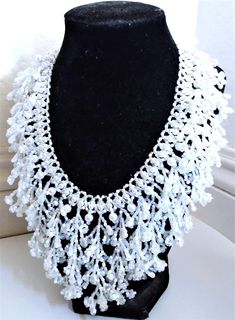 A handmade glass seed beaded necklace that is perfect for any occasion: parties, weddings, holidays, birthdays, anniversaries. All products are hand-crafted by my mother. Dimensions: - Collar Length: 20.5 cm - Actual Length: 29.0 cm - Width: 17.5 cm - Height: 7.0 mm Lightweight, high quality with a beaded hook as a clasp.  Acrylic Pearls: 8 mm. Will respond to concerns and suggestions promptly. Shipping costs: Free Domestic Shipping. All orders are sent by air-mail with tracking number. Time of delivery: Estimated 1-3 days for domestic shipping; international make take 7-14 days. Feel free to check out our other similar products! Link: https://noorsjewelers.etsy.com Handmade Elegant White Beads, White Necklaces With Colorful Beads For Party, Adjustable Beaded Bridal Necklace For Parties, Elegant Handmade White Beads, Bridal Necklace With Colorful Round Beads In White, White Bridal Necklace With Colorful Round Beads, Traditional White Beaded Necklaces With Bead Caps, Pearl Beaded Necklace With Colorful Beads For Weddings, White Beaded Necklaces With Colorful Beads For Weddings