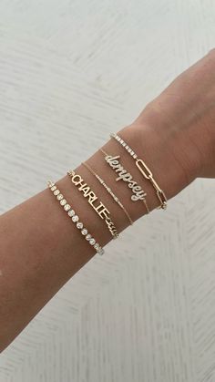 This gorgeous bracelet features the name of your choice in a script font set in diamonds. Price is based on the number of letters in the name. Example is shown in all lowercase letters. First letter uppercase is available also. Available in 14K Yellow, White or Rose Gold Chain Length: 6" + 0.5" extender Up to 8 letters only Letter height approx. 0.15 - 0.25" (varies per letter) FINAL SALE Luxury Yellow Gold Diamond Name Bracelet, Luxury Gold Name Bracelet With Diamond Accents, Luxury Name Bracelet With Diamond Accents, Gold Name Bracelet With Diamond Accents For Gift, Gold Name Bracelet With Diamond Accents, Letter Example, Font Setting, Rose Gold Chain, Gold Bar