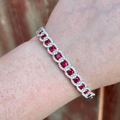 This elegant ruby and diamond bangle bracelet is crafted from 18K white gold and boasts 106 natural diamonds and 13 rubies of superior (G) color and (VS2) clarity for a total of 4.17CTW. Brilliantly cut and carefully prong set, this bracelet adds timeless sophistication to any ensemble. Diamond Bangle Bracelet, Diamond Bangles Bracelet, Diamond Bar, Diamond Bangle, Bangle Bracelet, Prong Setting, Natural Diamonds, Bangle Bracelets, Platinum