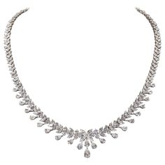 An impeccably designed diamond necklace featuring pear, marquise, and round cut diamonds. 18.20 carats of FG VS diamonds 18k white gold Approximately 16.5 inch length that can easily be adjusted. Outfits With Gold Jewelry, Gold Jewelry Women, Diamond Drop Necklace, Necklaces Choker, Vintage Choker Necklace, Diamond Necklace Designs, Vintage Choker, Big Diamond, Gold Diamond Necklace