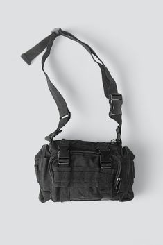 an empty black bag on a white background with strap around the waist and bottom compartment