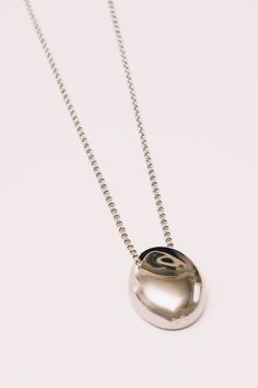 This minimal necklace has a mirrored finish with a high polish shine to add subtle sophistication to any look. Dimensions: Hangs 28" including pendant (1.25") (32mm) Materials: Stainless Steel, 18k Gold plating Ships in a branded jewelry pouch and box, perfect for gift giving! Luxury Tarnish-resistant Round Pendant Necklace, Gold-tone Metal Necklace With Plating, Stainless Steel Tarnish-resistant Round Pendant Necklace, Luxury Tarnish-resistant Stainless Steel Necklace, Elegant Enamel Medallion Necklace, Mirror Necklace, Minimal Necklace, Jewelry Pouch, Gift Giving