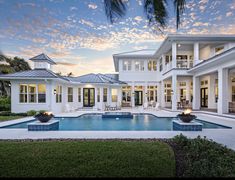 a large white house with a swimming pool