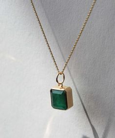 An emerald cut emerald set in 14k yellow gold. Each emerald has colors and textures unique to each stone. Specifications: 4 ct emerald set in 14k yellow gold. Stone is approximately 9.5x11 mm. Chain sold separately. Browse other chains here. Add our Carabiner to complete your look. Square Stone Pendant, Emerald Set, Bezel Necklace, Square Stone, Tourmaline Pendant, Bezel Pendant, Gold Stone, Yellow Gold Chain, Pear Diamond