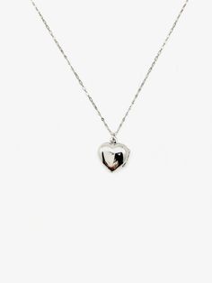 Embrace the nostalgia of the past and celebrate your love story with this heart-shaped sterling silver locket. A symbol of enduring love, this vintage gem is not just jewelry; it's a classic piece that spans decades. Discover timeless love with our Silver Jane Locket, a unique vintage treasure straight from the 1960s. The secure click-shut design ensures your cherished memories stay safely tucked away. The 17" sterling silver chain elegantly complements the locket, adding a touch of sophisticati Vintage Charm Heart Pendant Necklace For Anniversary, Vintage Heart Charm Necklace For Mother's Day, Anniversary Necklace With Vintage Charm And Heart Pendant, Vintage Charm Heart Pendant Jewelry For Mother's Day, Vintage Charm Heart Pendant Necklace For Mother's Day, Classic Heart-shaped Sterling Silver Necklace, Vintage Heart Charm Necklace For Valentine's Day, Mother's Day Heart Pendant Necklace With Vintage Charm, Mother's Day Vintage Charm Heart Pendant Necklace