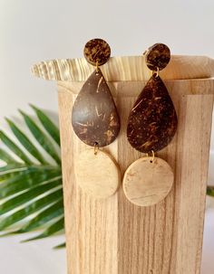 "Take the beach life everywhere you go! These gorgeous drop coconut shell earrings are so beautiful and perfect for every day! The eco-friendly earrings showcase the natural beauty of the coconut. The modern teardrop and circular geometric shape and detailed polished finish make these a one of a kind pair! Thoughtfully crafted from re-purposed dry coconut shells found by the Pacific seashores of El Salvador.  Each piece is carefully crafted by our artisan partners in a fair trade environment.  This drop dangle earrings design features two tones of coconut, off white and brown on the bottom. Each pair is unique because coconut has its natural color variation and marbling. There will never be two pieces alike.   Lightweight and easy to wear. With a 3.75 inch dangle,  they are crafted with 14 Coconut Room, Coconut Shell Earrings, Coconut Earrings, Coconut Jewelry, Coconut Shell Crafts, Coconut Shells, Sustainable Wardrobe, Wood Dangle Earrings, Coconut Wood