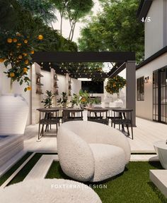 an outdoor living area with white furniture and greenery