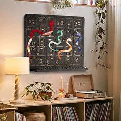 a record player is sitting on a shelf next to a table with records and a lamp