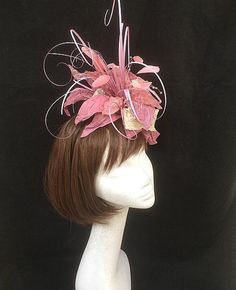 Pink and ivory flower fascinator. Wonderfully wild collection of heat treated fabrics including silks, nylons and satins teamed with synthetic grasses and scattered crystals. This design is the perfect combination of many textures and a wonderful example of how many different textile methods can be grouped together to produce the most wonderful creation. This design is set onto a fine comfort fascinator band. As with all our designs, this piece can be made exact to the image or in any colour com Elegant Pink Headband For Kentucky Derby, Elegant Pink Hair Accessories For Royal Ascot, Elegant Pink Headband Fascinator, Elegant Pink Hair Accessories For Kentucky Derby, Elegant Pink Wedding Headband, Whimsical Flower-shaped Fascinator With Handmade Flowers, Pink Wedding Fascinator Headband, Pink Handmade Flowers Headband For Wedding, Whimsical Pink Hair Accessories With Handmade Flowers