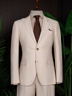 Color: beige Material: 73% polyester, 23% viscose, 4% elastane Suit includes blazer, waistcoat, & trousers Single-breasted suit (2-button blazer) Lapel type: peak lapels Jacket interior lining option: fully-lined Jacket vent: double vent Fitting: modern-fit Care instructions: dry clean only Machine washable: no Elegant Beige Tuxedo With Notch Lapel, Beige Fitted Tuxedo With Notch Lapel, Beige Single Breasted Tuxedo For Formal Occasions, Beige Single-breasted Tuxedo For Formal Occasions, Fitted Beige Tuxedo For Semi-formal Occasions, Cream Tuxedo Suit With Notch Lapel, Tailored Cream Tuxedo For Semi-formal Occasions, Luxury Beige Tuxedo For Business, Luxury Beige Business Tuxedo