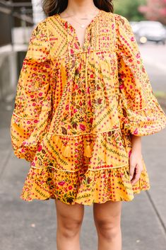 Officially obsessed! This dress is so eye catching! That floral print is so unique and we are loving the color combo! This flowy babydoll dress is perfect for now through fall! V-neckline with tied details Long bubble sleeves Babydoll fit Unique floral print No stretch Cindy is wearing the small. Yellow Flowy Dress With Boho Print, Flowy Yellow Boho Print Dress, Flowy Yellow Dress With Boho Print, Fall Vacation Printed Boho Dress, Printed Dress For Fall Brunch, Multicolor Floral Dress For Fall Vacation, Multicolor Bohemian Floral Dress For Fall, Printed Floral Dress For Fall Vacation, Yellow Printed Fall Dress