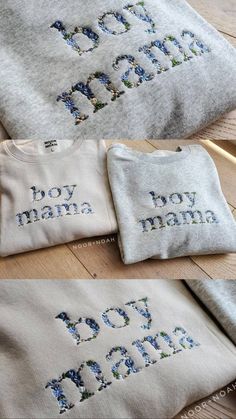 three t - shirts with the words boy mama written in blue flowers on them, sitting on a wooden surface