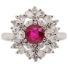 A Ruby and diamond ring. The ring's center stone is 1.08 carat pigeon blood Burmese ruby certified by Gem Research Swisslab (GRS). The center stone is surrounded by 0.95 carat mix shaped diamonds and mounted on 18K white gold gross weight 6.19 g. Burmese Ruby, Ruby And Diamond Ring, Blood Diamond, Royal Jewels, July Birthstone, Pretty Rings, Lovely Jewellery, Crystal Gems, Bridal Rings