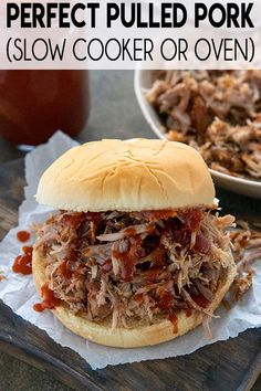 a pulled pork slow cooker or oven sandwich with bbq sauce on the side