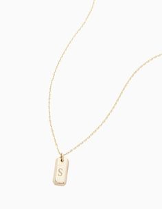 a gold necklace with the letter s on it