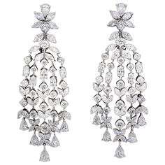 A beautiful pair of grand earrings. 15.84 carats of white round, pear, and marquise cut diamonds set in 18k white gold. A grand design that mimics those found on the red carpet today -- perfect for your next black tie affair! Approximately 2.55 inches from the highest to lowest point, just under an inch wide at its widest point. Made in New York Grand Chandelier, Modern Diamond Jewelry, Real Diamond Earrings, Pearl Chandelier Earrings, Diamond Chandelier Earrings, Dancing Diamond, Diamond Chandelier, Rose Gold Hoop Earrings, Silver Jewelry Diy